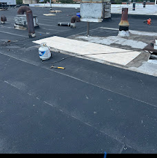 Flat-roof work around raised curbs and roof penetrations.