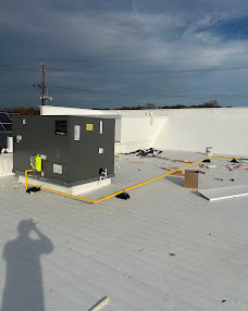 Roof surface and flashing details surrounding rooftop equipment.